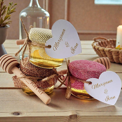 Decorative jars with heart-shaped name tags on a wooden table.