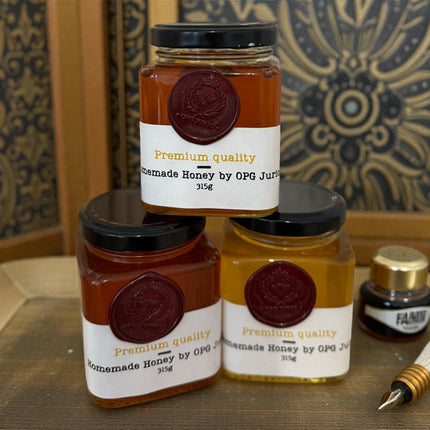 Jars of homemade honey with visible labels on a decorative background