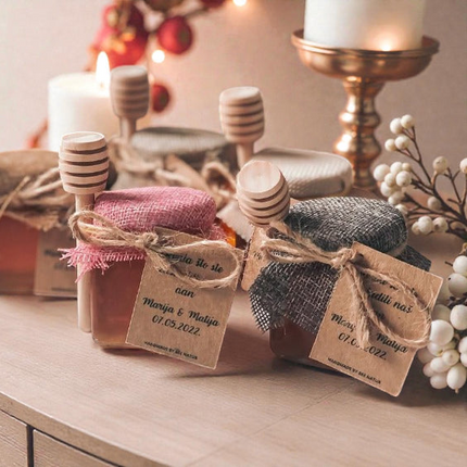 Three small jars with wooden lids on a table with decorative elements.